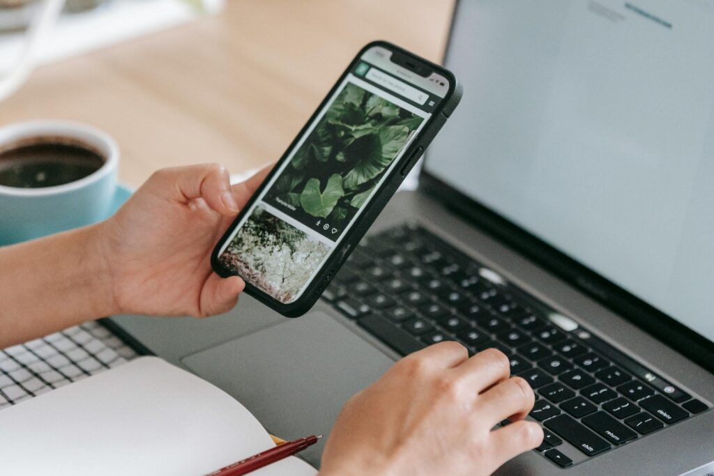 Content Marketing einfach erklärt 5 Person vergleicht Inhalte auf dem Handy und auf dem Laptop
