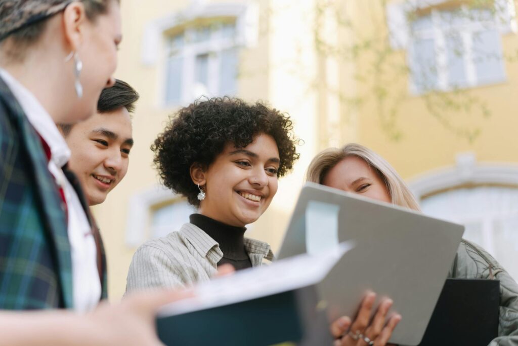Generation Z und ihre Erwartungen an nachhaltige Markenkommunikation 1 Eine Gruppe von Freunden schaut gemeinsam auf einen Laptopscreen